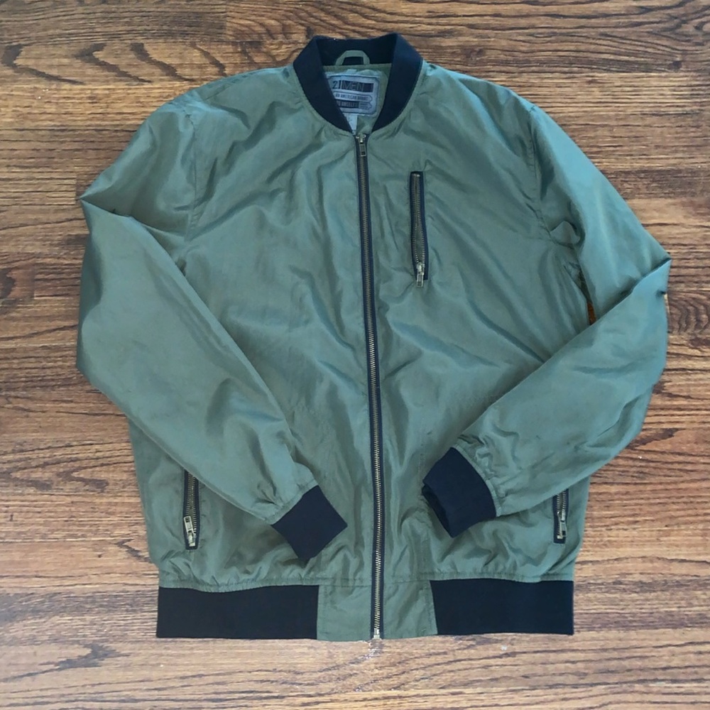 Green and black light jacket with gold zippers